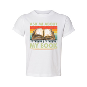 Unisex Tee With Open Book Illustration And Retro Rainbow Stripes Featuring Ask Me About My Book